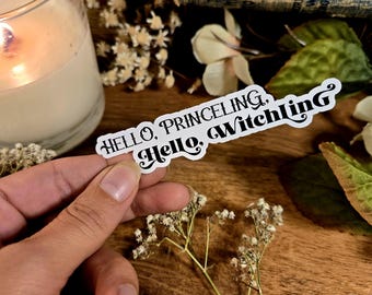 May include: White sticker with black text that reads "Hello, Princeling. Hello, Witchling."