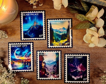 May include: Five colorful postage stamps with fantasy cityscapes. Each stamp features a different city name, including "Glass Palace", "Crescent City", "Velaris", "Terrassen", and "Night Court". Each stamp has a 10¢ price.