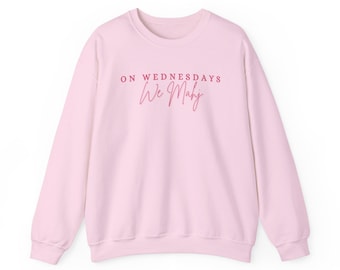 May include: A pink sweatshirt with the text "ON WEDNESDAYS We Make" in pink.