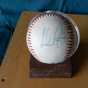 Nolan Ryan AUTOGRAPHED Baseball with Certificate of Authenticity from JSA & Baseball Stand.