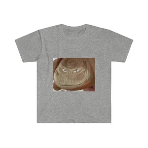 May include: A gray t-shirt with a close-up image of a brown furry creature with a wide, toothy grin.