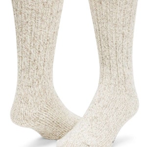 May include: A pair of cream-colored socks with a textured knit pattern.