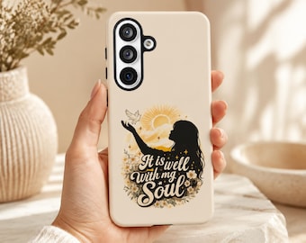 May include: A beige smartphone case featuring a black silhouette of a person reaching toward a white dove. Above the person is a yellow sun, and below is a floral arrangement with the text "It is well with my soul" in a decorative script font.