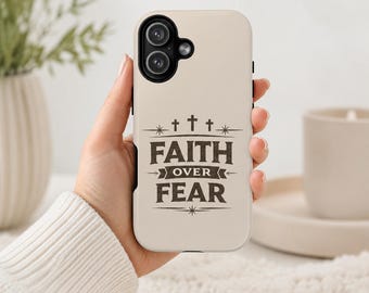 May include: A cream-colored smartphone case featuring a dark brown graphic design with three small crosses at the top and the text "FAITH OVER FEAR" centered in a bold, stylized font, accented with decorative lines and star-like symbols.