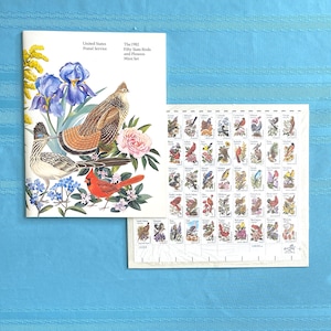 May include: A set of 1982 United States Postal Service stamps featuring birds and flowers from each state. The set includes a booklet with illustrations of the birds and flowers, and a sheet of 50 stamps.