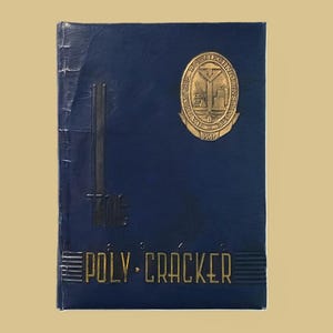 May include: A vintage blue yearbook titled "The Poly-Cracker" with gold lettering and a gold emblem. The emblem reads "Baltimore Polytechnic Institute" and the year "1946". The cover has vertical black lines.