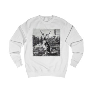May include: White long-sleeve sweatshirt with a black and white image of a deer in a forest setting. The text "The classic Malguster Buckskin c. 1903" is printed below the image.