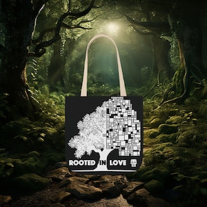 May include: Black tote bag featuring a white tree graphic, split into a detailed tree and a geometric design. The text "ROOTED IN LOVE" is below the tree. The bag has beige handles, set against a forest backdrop.