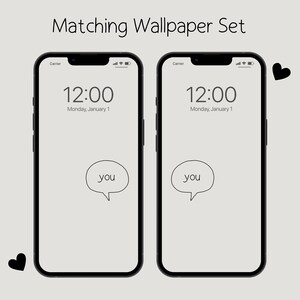 May include: Two matching phone wallpapers with a white background, black text that reads "12:00 Monday, January 1", and a speech bubble with the word "you" inside.  Each phone wallpaper has a small black heart in the corner.