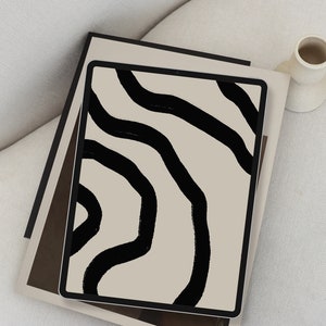 May include: A tablet computer displaying a digital illustration of black abstract lines on a beige background.