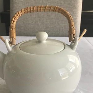 Vintage white ceramic Japanese teapot with rattan handle
