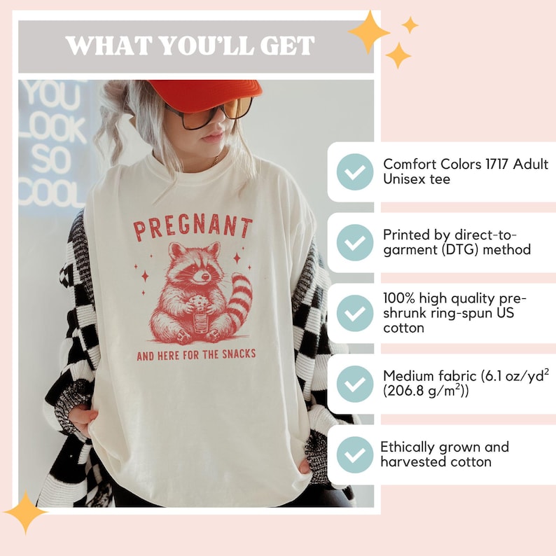 May include: White unisex t-shirt with a red raccoon graphic and the text "PREGNANT AND HERE FOR THE SNACKS".