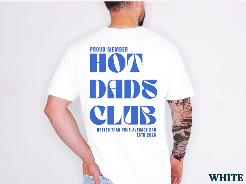 May include: White t-shirt with the text "PROUD MEMBER HOT DADS CLUB" in blue, with "Hotter Than Your Average Dad ESTD 2026" below. The shirt is a classic crew neck style.
