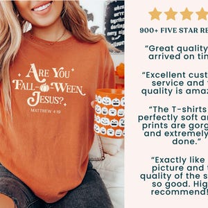 May include: Orange long-sleeved shirt with the text "Are You Fall-Ween Jesus?" and Matthew 4:19. A person is holding a pumpkin-themed mug. The image also includes a carved pumpkin and customer reviews.