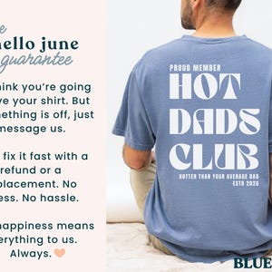 May include: A blue jean-colored t-shirt with the text "HOT DADS CLUB" in white, with "HOTTER THAN YOUR AVERAGE DAD ESTD 2026" below. The shirt is being worn by a person.