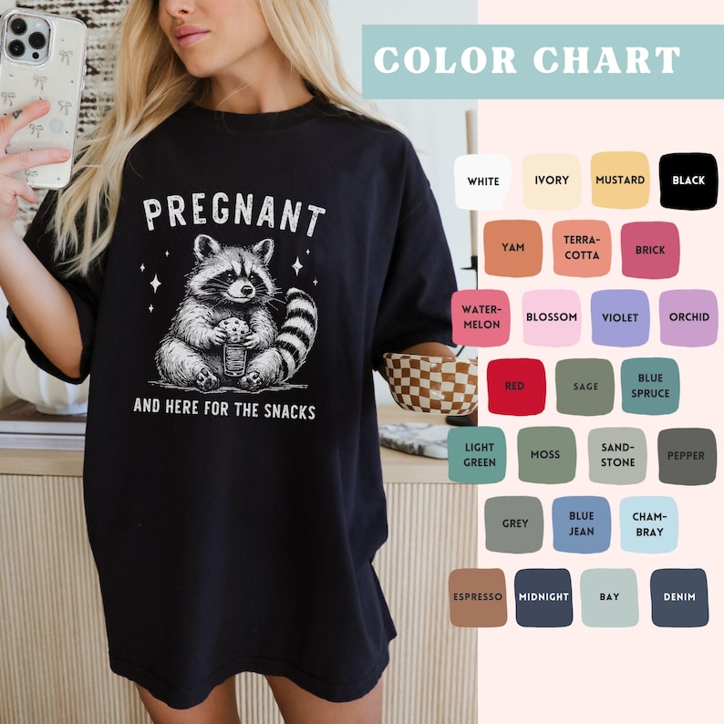 May include: Black oversized t-shirt with a graphic of a raccoon holding a jar of snacks and the text "PREGNANT AND HERE FOR THE SNACKS".