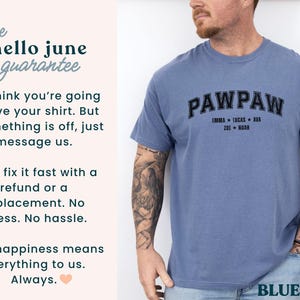 May include: A blue jean-colored t-shirt with the word "PAWPAW" in black arched lettering. Below the word are the names Emma, Lucas, Ava, Zoe, and Noah. The shirt is worn by a person with tattoos on their arm.