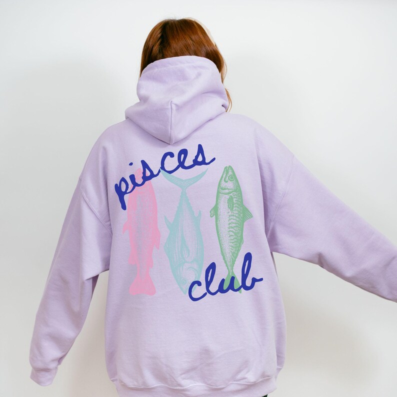 May include: A lavender hoodie with a graphic of three fish and the text "Pisces Club" printed on the back.