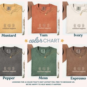 May include: A color chart featuring six t-shirts in various colors: mustard, yam, ivory, pepper, moss, and espresso. Each shirt has a gold necklace and the text "schnitzel happens". The image includes the text "color chart".