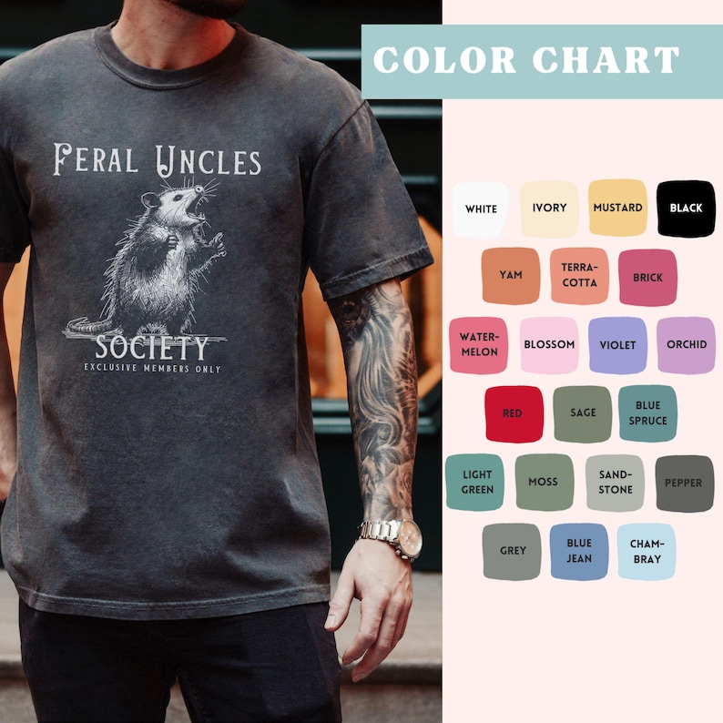 May include: A dark gray t-shirt with a white graphic of an opossum with the text "Feral Uncles Society Exclusive Members Only". The image also includes a color chart with various color swatches.
