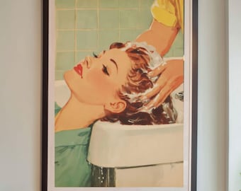 May include: A vintage-style illustration of a woman getting her hair washed in a salon, framed in a black frame. The illustration is in a retro style with a woman with red hair and a blue shirt. The salon has black leather chairs and a white countertop.