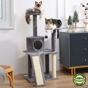 May include: A grey cat tree with a scratching post, a platform, and a tunnel. Two cats are sitting on the platforms. The cat tree is in a room with a dresser and a chair.
