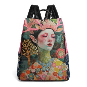 May include: A black backpack with a colorful print featuring a woman with antlers, flowers, and a forest scene. The woman is wearing a kimono with a floral pattern.