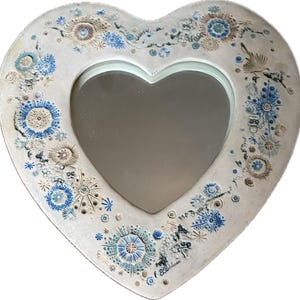 May include: A set of three ceramic mugs with a speckled, matte finish. Each mug features a different color: light blue, cream, and gray. The mugs have a simple, modern design and a comfortable handle.