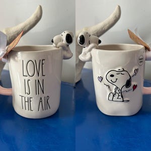 Rae Dunn Peanuts Snoopy Valentine’s Day Love Is In the Air Double Sided Mug with Snoopy on the Rim