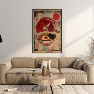 May include: A vintage-style poster featuring a bowl of ramen noodles with an egg, seaweed, and green onions. The poster has a red and white color scheme with Japanese characters and a red circle in the background.