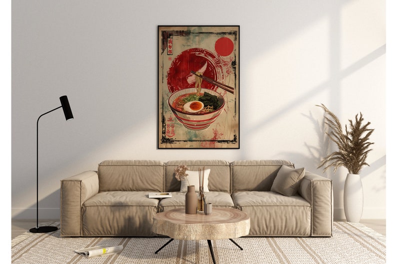 May include: A vintage-style poster featuring a bowl of ramen noodles with an egg, seaweed, and green onions. The poster has a red and white color scheme with Japanese characters and a red circle in the background.