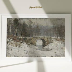 May include: Framed vintage print of a winter landscape. A stone bridge arches over a snowy stream, with bare trees and a forest in the background. The artwork is in a white frame, with the text "Elegant Art Prints" in the upper right corner.
