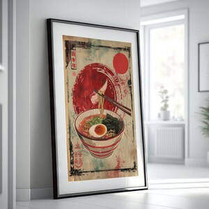 May include: A vintage-style poster featuring a bowl of ramen with chopsticks, a red circle, and Japanese text. The poster has a distressed, aged look.