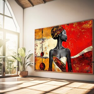 May include: Abstract painting of a woman with a red, yellow, and gold background. The woman is wearing a head wrap and a white dress. The painting is framed and hanging on a white wall.