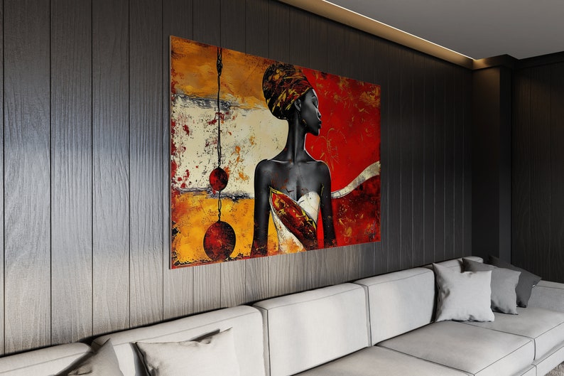 May include: Abstract painting of a woman with a red, yellow, and white background. The woman is wearing a white and red patterned dress and has a red head wrap. The painting is framed and hanging on a dark wood wall.