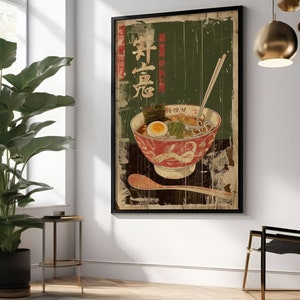 May include: Vintage-style poster featuring a bowl of ramen with chopsticks, a spoon, and Japanese text. The poster has a distressed, aged look with a green background.