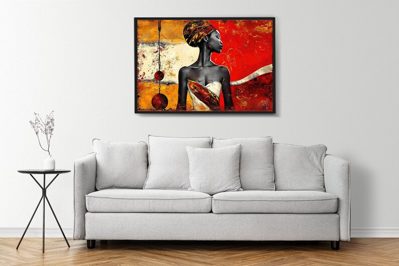 May include: Abstract painting of a woman with a red, yellow, and gold background. The woman is wearing a white dress and a head wrap. The painting is framed in black.