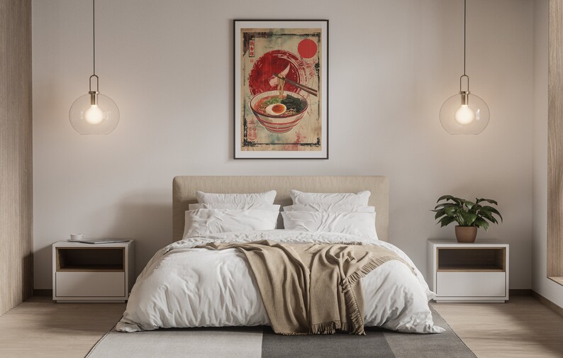 May include: A white bed with a tan blanket and two white pillows. A framed poster of a bowl of ramen with chopsticks hanging over the bowl is hanging on the wall above the bed. There are two nightstands with lamps on either side of the bed.