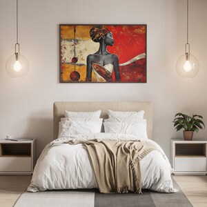 May include: A bedroom interior with a white bed, a brown throw blanket, and two white nightstands. A painting of a woman with a red background hangs on the wall above the bed. Two clear glass globe pendant lights hang from the ceiling.