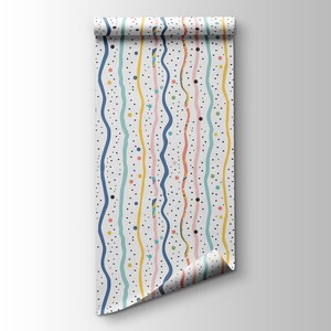 May include: A white wallpaper roll with a colorful pattern of wavy lines and dots. The lines are in shades of blue, pink, yellow, and green. The dots are black.