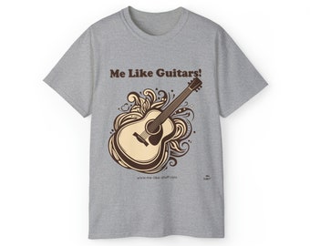 May include: A grey t-shirt with the text "Me Like Guitars!" printed on the front. The design features a brown acoustic guitar with a floral pattern.