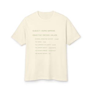 May include: Cream-colored t-shirt with the text "SUBJECT: HOMO SAPIENS, OBJECTIVE: DECODE VALUES" and other phrases. The shirt's design includes the phrases "INTERNAL OPERATING SYSTEM - mindset", "THE VESSEL - body", "THE CURRENCY OF WORTH - career", "THE UNSEEN WEIGHT - responsibility", "THE HUMAN MIRROR - relationships", and "THE SACRED ESCAPE - fun".