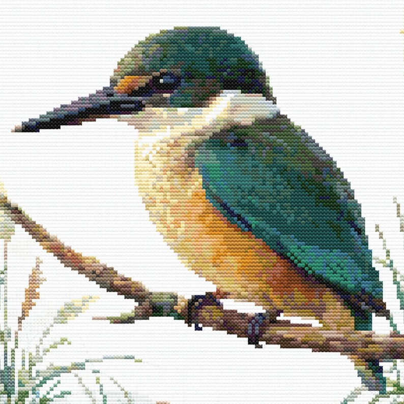 Close-up of Sacred Kingfisher Kōtare Cross Stitch Pattern showing the bird’s blue-green feathers, long beak, branch detail, and visible counted cross stitch texture.