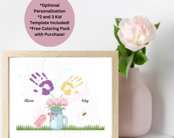 May include: A framed print with a handprint art design featuring a yellow and purple handprint with the names Allison and Riley. The print has a floral theme with a mason jar filled with flowers and a bee.