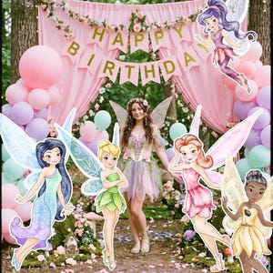 May include: A birthday celebration featuring a woman in a fairy costume, fairy cutouts, balloons, and a banner reading "Happy Birthday." The setting includes pink drapes and floral arrangements, creating a magical ambiance.
