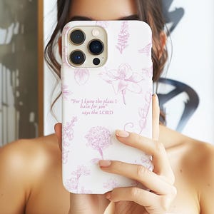 May include: White iPhone case with a floral design and the quote "For I know the plans I have for you" says the Lord.