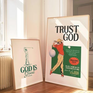 May include: Two framed art prints with golf-themed illustrations and inspirational text. One print reads "GOD IS Good" with a golfer graphic. The other says "TRUST GOD" with a golfer and a bible verse. Both are in wooden frames.
