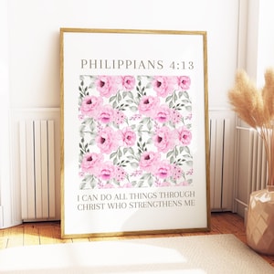 May include: A framed print with a floral design of pink watercolour roses and green leaves on a white backdrop. The text "PHILIPPIANS 4:13" is at the top, with "I CAN DO ALL THINGS THROUGH CHRIST WHO STRENGTHENS ME" below the floral design. The frame is gold.