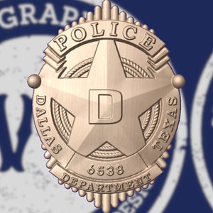 Puede incluir: Una placa de policía de color dorado con una estrella de cinco puntas, las palabras "DALLAS" y "TEXAS" a cada lado de la estrella, y las palabras "POLICE DEPARTMENT" alrededor del borde. La placa también tiene el número "6538" y la letra "D" en el centro.