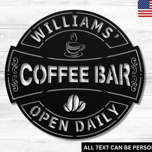 May include: Black metal sign with the text "WILLIAMS, COFFEE BAR OPEN DAILY" in a white font. The sign features a stylized coffee cup and coffee beans.
